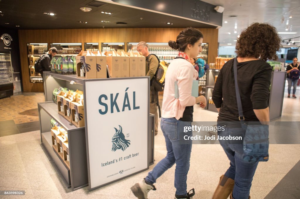 Tourists shopping at duty free stores while waiting for departing flights at Keflavik International Airport, Iceland