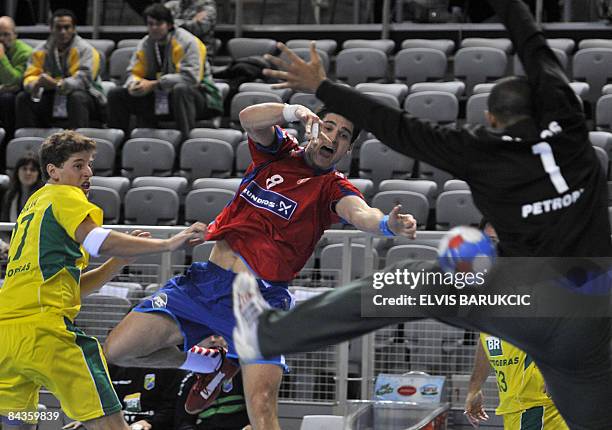 Serbia's Nenad Vuckovic scores against Brazil's goalkeeper Maik Santos during their men�s World Handball Championships Group D match on January 19,...