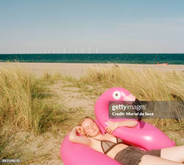Young woman sleeping in bathing ring