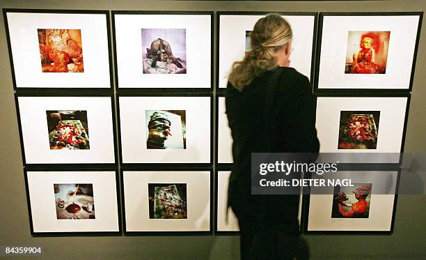 Visitor views photographs of action artist Otto Muehl during a press preview of a new exhibition "Der chirurgische Blick" about the Viennese...