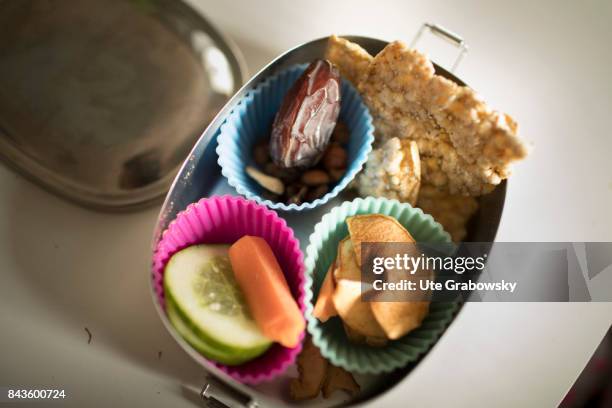 Bonn, Germany View from above in a breakfast box with cucumber, carrot, date, nuts, crispbread and dried fruit on March 14, 2017 in Bonn, Germany.