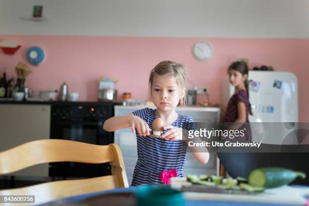 Bonn, Germany A five-year-old girl helps to cover the breakfast table and carries a boiled egg on August 07, 2017 in Bonn, Germany.