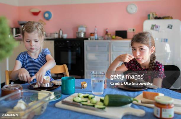 Bonn, Germany A five and a seven-year-old girl are having breakfast together and eat boiled eggs on August 07, 2017 in Bonn, Germany.