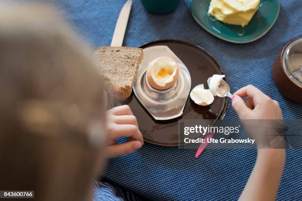 Bonn, Germany View from above on a five-year-old girl, who is eating a boiled egg on August 07, 2017 in Bonn, Germany.