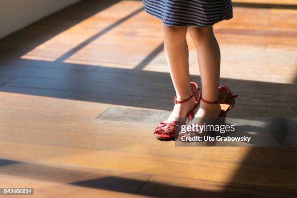Bonn, Germany A girl is wearing too big women's shoes on August 07, 2017 in Bonn, Germany.