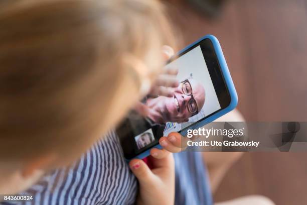 Bonn, Germany A girl talks to her grandfather via Facetime on August 07, 2017 in Bonn, Germany.