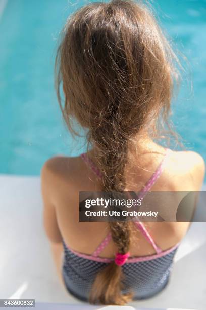 Bonn, Germany Back view of a seven-year-old girl with a plaited pigtail at a swimming pool on August 07, 2017 in Bonn, Germany.