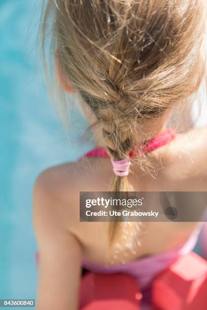 Bonn, Germany Back view of a five-year-old girl with a plaited pigtail at a swimming pool on August 07, 2017 in Bonn, Germany.