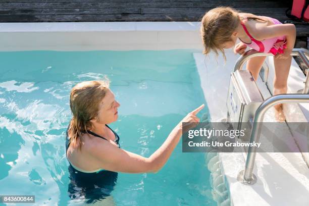 Bonn, Germany Mother and daughter bathing in their swimming pool with countercurrent system on August 07, 2017 in Bonn, Germany.