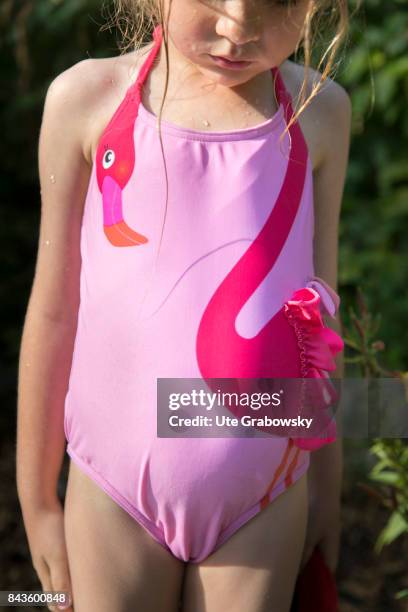 Bonn, Germany A five-year-old girl is wearing a pink swimsuit with flamingo appliqué on August 07, 2017 in Bonn, Germany.