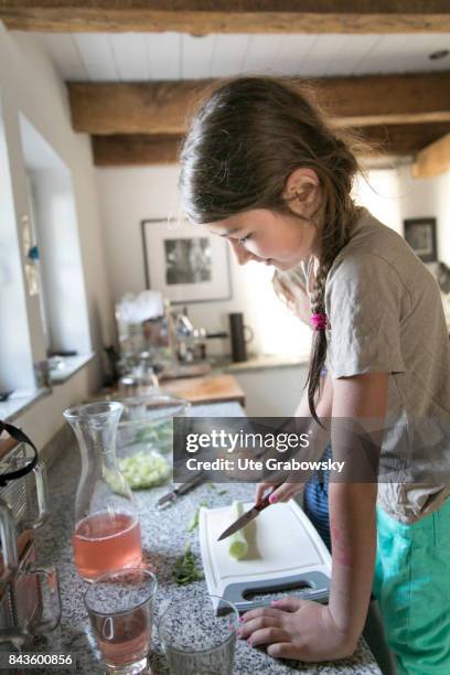 Bonn, Germany A sevven-year-old girl helps to prepare a meal and cuts a cucumber on August 07, 2017 in Bonn, Germany.