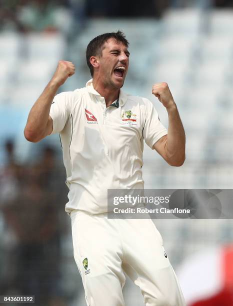 Pat Cummins of Australia celebrates after taking the wicket of Mushfiqur Rahim of Bangladesh during day four of the Second Test match between...