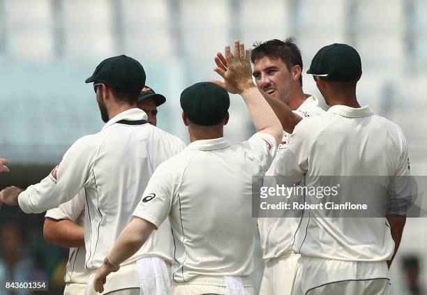 Pat Cummins of Australia celebrates after taking the wicket of Mushfiqur Rahim of Bangladesh during day four of the Second Test match between...