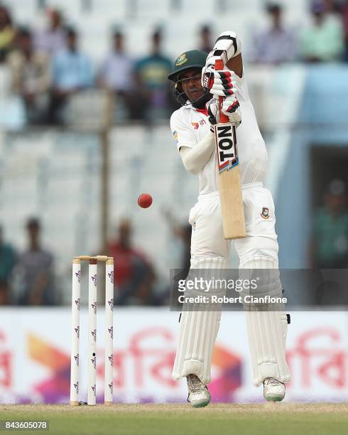Mehedy Hasan Miraz of Bangladesh is struck by a deliver from Pat Cummins of Australia during day four of the Second Test match between Bangladesh and...