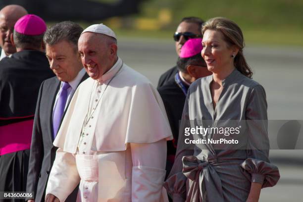 Pope Francis gestures next to Colombian President Juan Manuel Santos and first lady Maria Clemencia Rodriguez during his welcoming ceremony upon...