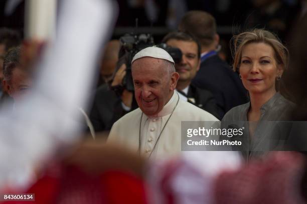 Pope Francis stands with Colombian President Juan Manuel Santos and First Lady Maria Clemencia during his welcoming ceremony upon landing in Bogota...