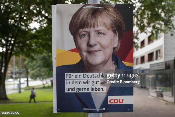 An election poster for Germany's Chancellor and Christian Democratic Union leader Angela Merkel sits on a lamp post in the Feldmark district of...