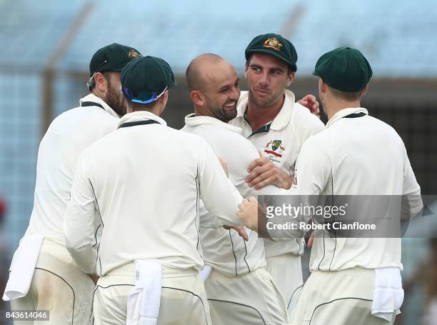 Nathan Lyon of Australia and Pat Cummins celebrate after they combined to dismiss Mominul Haque of Bangladesh during day four of the Second Test...