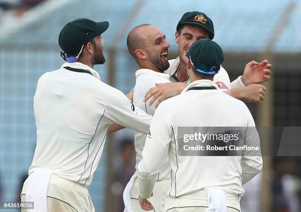 Nathan Lyon of Australia and Pat Cummins celebrate after they combined to dismiss Mominul Haque of Bangladesh during day four of the Second Test...