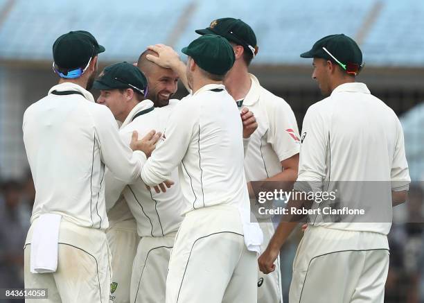 Nathan Lyon of Australia and Pat Cummins celebrate after they combined to dismiss Mominul Haque of Bangladesh during day four of the Second Test...