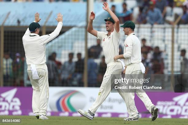 Pat Cummins of Australia celebrates after he caught Mominul Haque of Bangladesh during day four of the Second Test match between Bangladesh and...