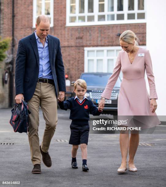 Britain's Prince George accompanied by Britain's Prince William , Duke of Cambridge arrives for his first day of school at Thomas's school where he...