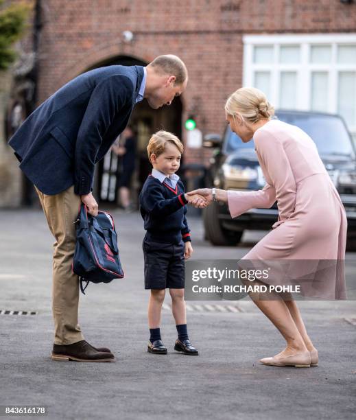 Britain's Prince George accompanied by Britain's Prince William , Duke of Cambridge arrives for his first day of school at Thomas's school in...