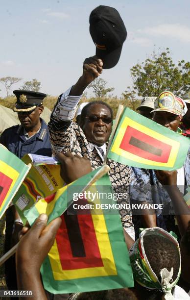 Zimbabwe's President Robert Mugabe greets supporters at a rally in Banket, 70 kms from Harare on June 24, 2008. President Mugabe said the elections...