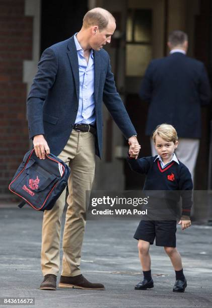 Prince George of Cambridge arrives for his first day of school with his father Prince William, Duke of Cambridge at Thomas's Battersea on September...