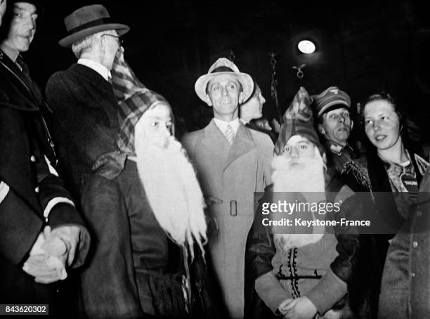 Le ministre allemand de l'Economie Hjalmar Schacht et le ministre de la Propagande Goebbels entourés de Père Noël sur le marché de Noël à Berlin,...