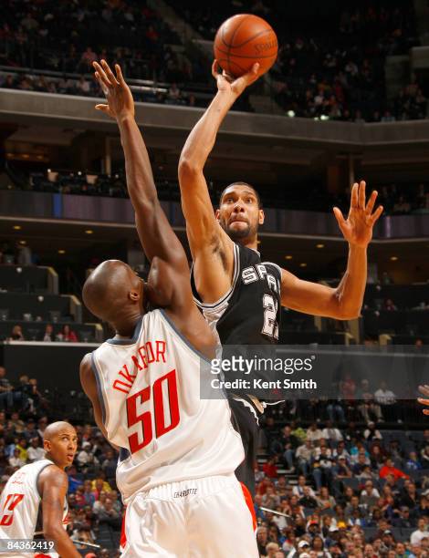 Tim Duncan of the San Antonio Spurs shoots around Emeka Okafor of the Charlotte Bobcats on January 19, 2009 at the Time Warner Cable Arena in...