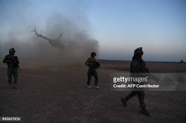 In this photograph taken on August 27, 2017 Afghan Commandos participate in a combat training exercise at Shorab Military Camp in Lashkar Gah in...
