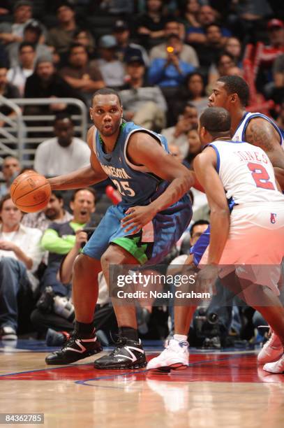 Al Jefferson of the Minnesota Timberwolves is guarded by Fred Jones and DeAndre Jordan of the Los Angeles Clippers at Staples Center on January 19,...