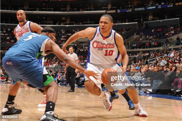 Eric Gordon of the Los Angeles Clippers drives against Craig Smith of the Minnesota Timberwolves at Staples Center on January 19, 2009 in Los...