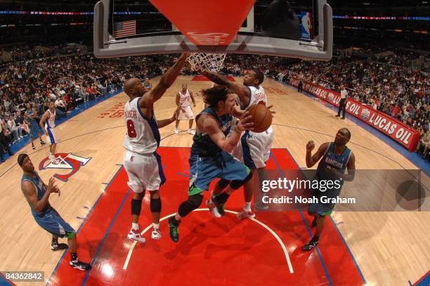 Mike Miller of the Minnesota Timberwolves leaves his feet to make a pass to teammate Al Jefferson during their game against the Los Angeles Clippers...