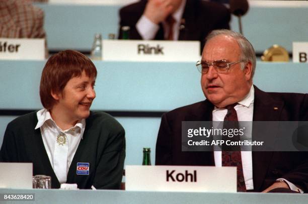 This picture taken on December 16, 2001 shows the then-German Chancellor Helmut Kohl and his then-newly elected Minister for Women, Angela Merkel,...