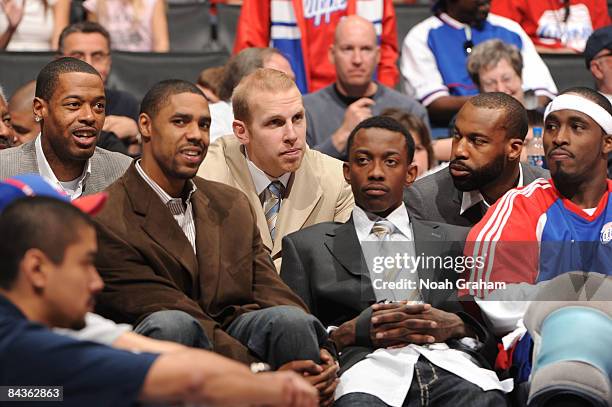 Marcus Camby, Jason Hart, Chris Kaman, Mike Taylor, Baron Davis, and Ricky Davis of the Los Angeles Clippers watch from the bench during a game...