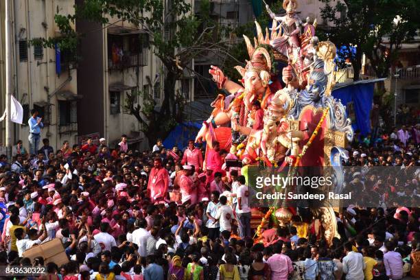 devotees in the procession with idol of the god ganesh - ganesh chaturthi stock pictures, royalty-free photos & images