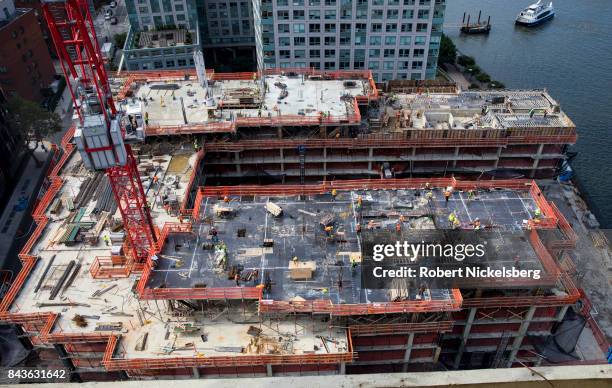 Employees of a construction company continue work on the new apartment complex called 420 Kent on August 17, 2017 in Brooklyn, New York. The...