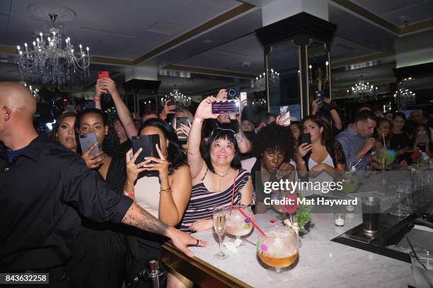 Fans watch and take photos as global icon Mariah Carey announces Mariah Carey Christmas Factory during The grand opening Of Sugar Factory American...