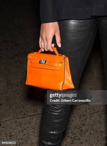 Lori Harvey, handbag detail, arrives to the Tom Ford Spring/Summer 2018 Runway Show at Park Avenue Armory on September 6, 2017 in New York City.