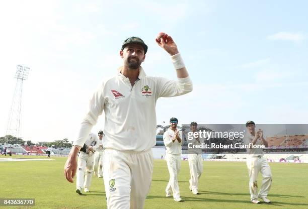 Nathan Lyon of Australia holds up the ball after he took 13 wickets for the match during day four of the Second Test match between Bangladesh and...