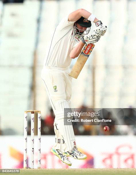 Matthew Renshaw of Australia defends a rising delivery from ustafizur Rahman of Bangladesh during day four of the Second Test match between...