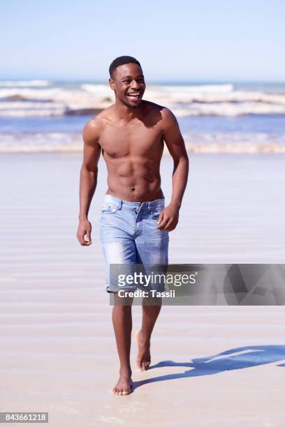 his body was built for the beach - hunky guy on beach stock pictures, royalty-free photos & images
