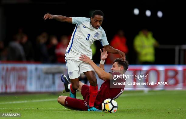 Kyle Walker-Peters of England U21 is tackled by Vladislavs Fjodorovs of Latvia U21 during the UEFA Under 21 Championship Qualifier match between...