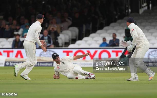 Alastair Cook of England puts down a catch off Kraigg Brathwaite of West Indies as captain Joe Root and wicket keeper Jonny Bairstow look on during...