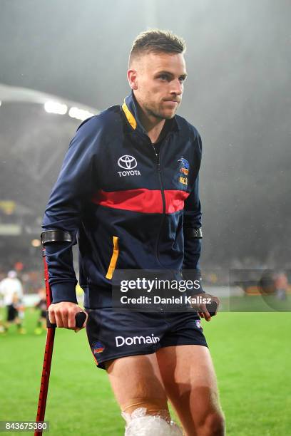 Brodie Smith of the Crows walks from the field at half time with a suspected knee injury during the AFL First Qualifying Final match between the...