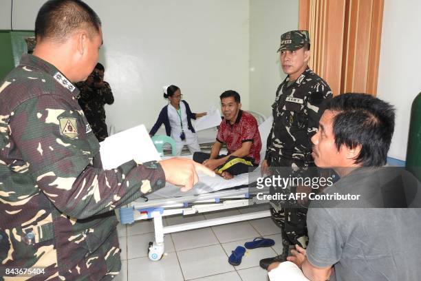 Indonesian nationals Sarapuddin Koni and Sawal Maryam , who escaped after being kidnapped by the Abu Sayyaf group, are interviewed by Philippine...