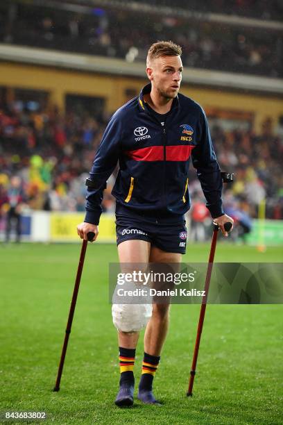 Brodie Smith of the Crows walks from the field at half time with a suspected knee injury during the AFL First Qualifying Final match between the...