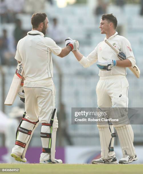 Glenn Maxwell and Peter Handscomb of Australia celebrate after Australia defeated Bangladesh during day four of the Second Test match between...